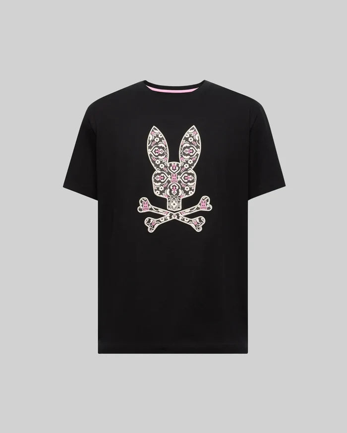 Mens Big And Tall Luke Graphic Tee, a black classic fit jersey t-shirt with a large, centered Psycho Bunny skull and crossbones graphic, intricately patterned in white and pink florals, finished with a pink inner collar.