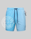 Mens Big And Tall Samos Hydrochromic Swim Trunk in light blue, revealing a subtle water-activated Psycho Bunny skull and crossbones pattern on the left, solid right, with dark blue branded drawstrings.