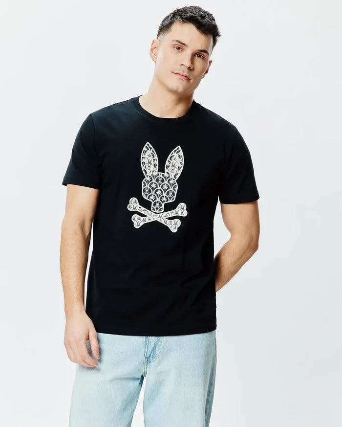 Black Mens Brad Graphic Tee, a classic fit jersey t-shirt with a large, centered white Psycho Bunny skull logo intricately patterned with small palm trees and motifs.