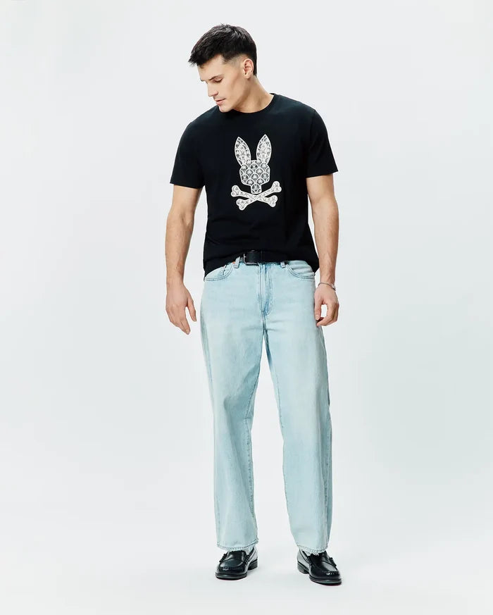 Mens Brad Graphic Tee, black classic fit jersey t-shirt featuring a large white paisley-filled Psycho Bunny skull logo on the chest.