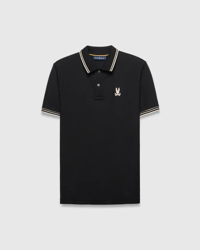 Mens Brad Pique Polo, black classic fit with white and gold striped collar and cuffs, featuring a small embroidered light pink/cream Psycho Bunny skull logo on the left chest.