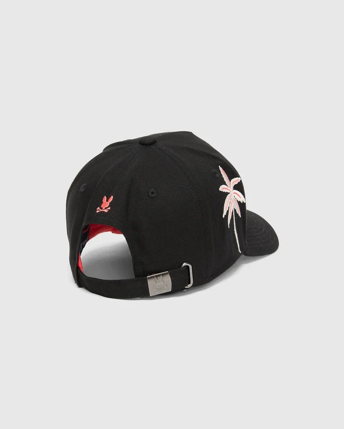 Black Mens Brad Trucker Cap with red underbrim, featuring an embroidered pink and white palm tree on the side, a small red Psycho Bunny skull on the back, and an engraved bunny skull on the metal buckle.