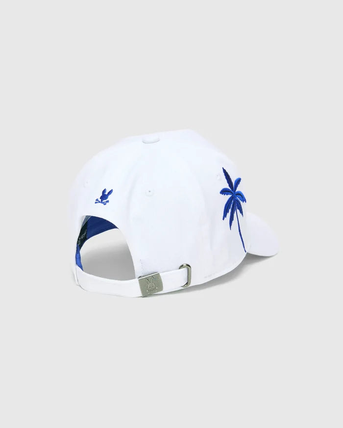 White Mens Brad Trucker Cap with blue interior, featuring a vibrant blue embroidered palm tree on the side, a small blue embroidered Psycho Bunny skull on the back, and a branded metal buckle.