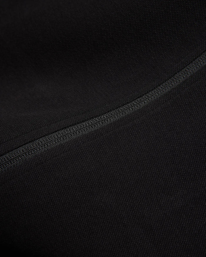 Black Mens Ceano Track Jacket featuring a smooth, finely textured knit fabric, accented by a prominent, precisely stitched flatlock seam running diagonally across the garment.