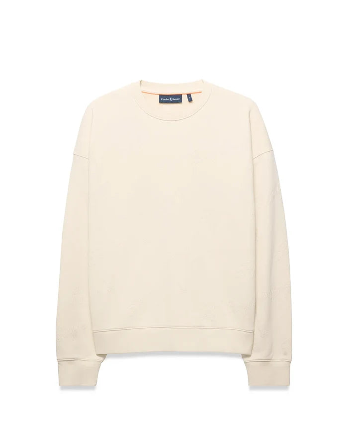 Mens Cedrick All Over Jacquard Crew. Cream relaxed fit crewneck sweatshirt featuring a subtle all-over tonal Psycho Bunny logo jacquard pattern and small embroidered bunny skull logo on left chest.