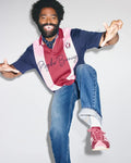 Mens Chad Relaxed Fit Striped Polo in navy, pink, and burgundy jersey knit, featuring vertical stripes, a small embroidered bunny skull on the left chest, and large script Psycho Bunny text across the front.