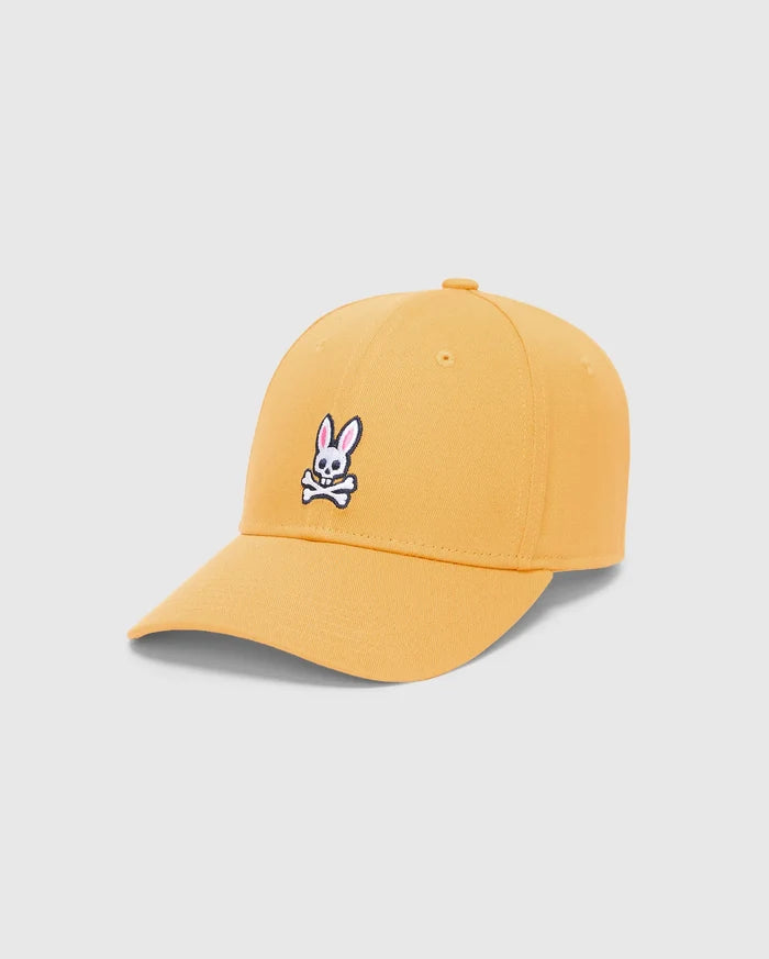 Mens Classic Baseball Cap in vibrant mustard yellow twill, featuring a prominent embroidered white, black, and pink iconic Psycho Bunny skull logo centered on the front.