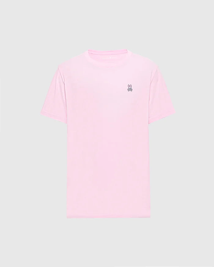 The light pink Men's Classic Crew Neck Tee (B6U014CRPC) by Psycho Bunny is crafted from soft pima cotton with a small embroidered peace sign hand symbol on the top left chest against a plain gray background, making it versatile and stylish for any casual occasion.