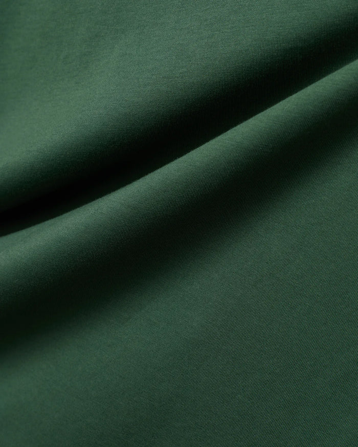 Mens Classic Crew Neck Tee in rich, deep forest green, crafted from premium, soft-touch jersey fabric, showcasing a refined, subtle knit texture and elegant, flowing drapes.