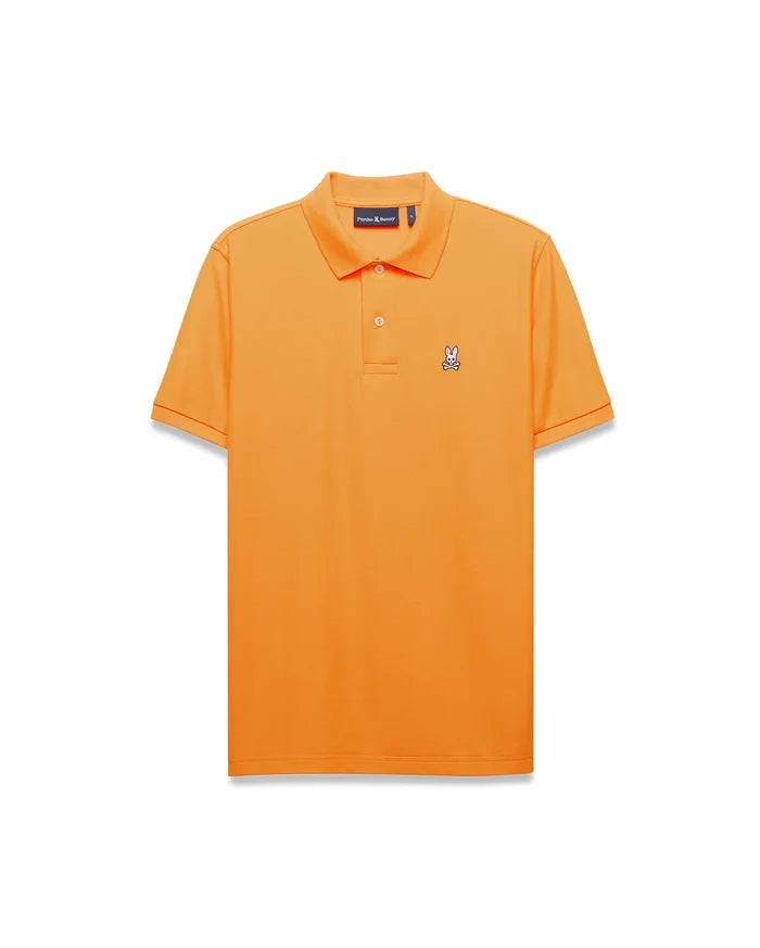 Mens Classic Pique Polo in vibrant orange, featuring a classic fit, pique fabric, two-button placket, ribbed collar, and a small embroidered white, black, and pink Psycho Bunny skull logo on the left chest.