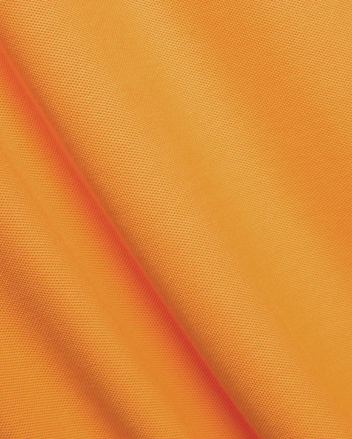 Mens Classic Pique Polo in vibrant orange, crafted from textured pique knit fabric, featuring the iconic small embroidered Psycho Bunny skull logo on the left chest.