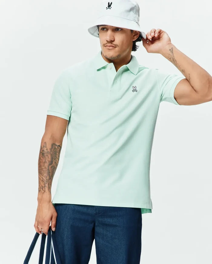 Premium mint green Mens Classic Pique Polo, designed with a classic fit and featuring a small, embroidered Psycho Bunny skull logo on the left chest.