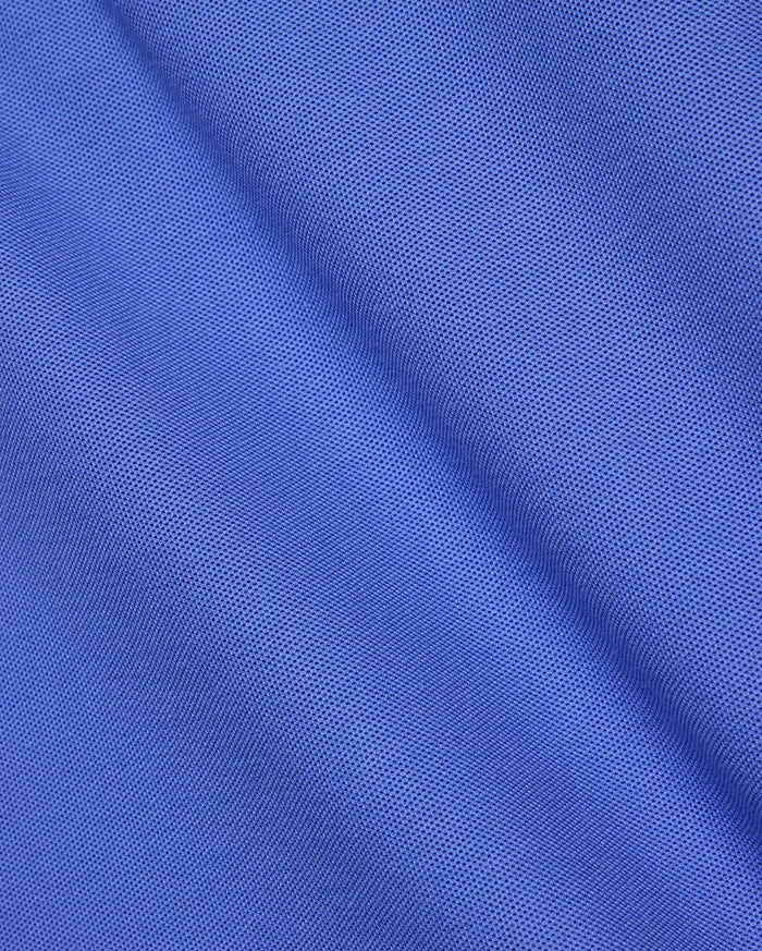 Premium Mens Classic Pique Polo by Psycho Bunny, crafted from a vibrant royal blue, finely textured pique knit fabric with a subtle sheen and soft drape, embodying refined streetwear style.