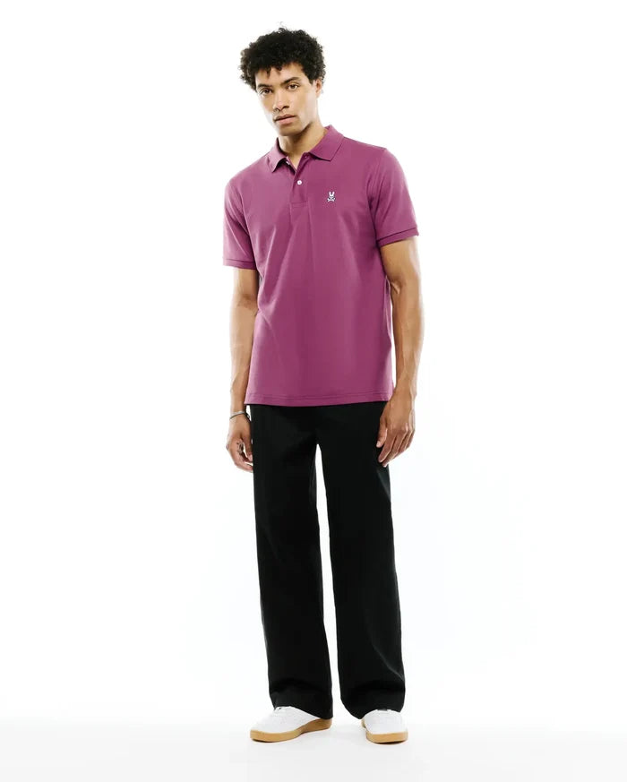 Mens Classic Pique Polo in deep plum pique fabric with a classic fit, featuring a two-button placket and a small white embroidered Psycho Bunny skull logo on the left chest.