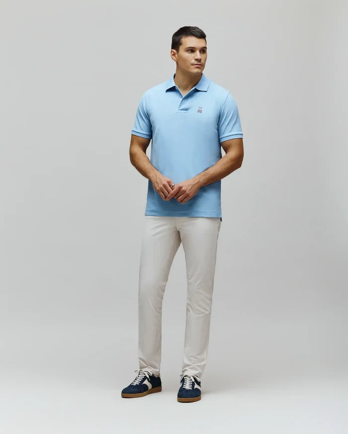 Mens Classic Pique Polo in light blue, featuring a classic fit, textured pique fabric, and a small embroidered white Psycho Bunny skull logo on the left chest.