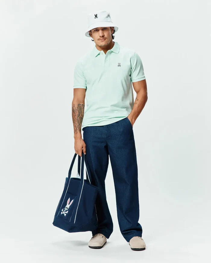 Mens Classic Pique Polo in pale mint green, featuring a classic fit and textured pique fabric, with a small embroidered black and white Psycho Bunny skull logo with pink ears on the left chest.