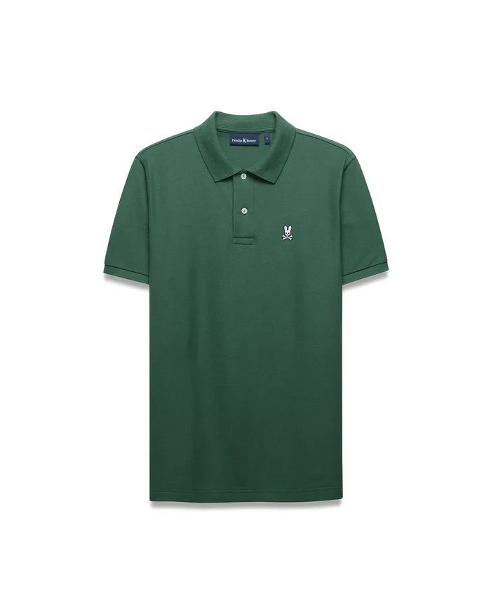 Mens Classic Pique Polo in dark green, featuring a classic fit and textured pique fabric. It has a two-button placket, ribbed collar, and a small embroidered pink Psycho Bunny skull logo on the left chest.
