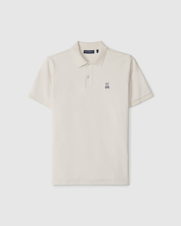 A timeless men's classic pique polo in luxurious Pima cotton, this plain, short-sleeved shirt in off-white features a collar, two buttons, and a small embroidered bunny logo on the left chest. The product is the MENS CLASSIC PIQUE POLO SHIRT - B6K001B200 by Psycho Bunny.