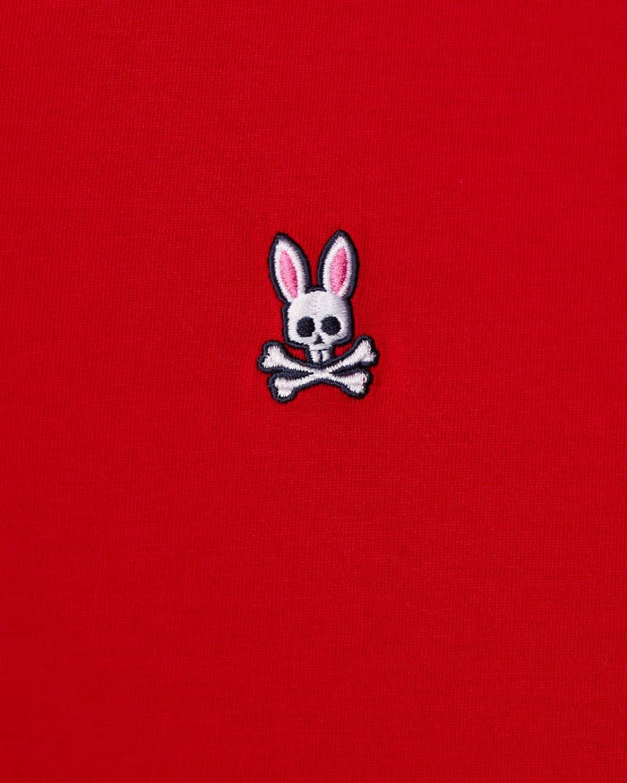 The MENS CLASSIC V NECK TEE - B6U100CRPC from Psycho Bunny showcases a red fabric made of soft Pima cotton and features the brand's signature logo: a white skull and crossbones with playful pink bunny ears.