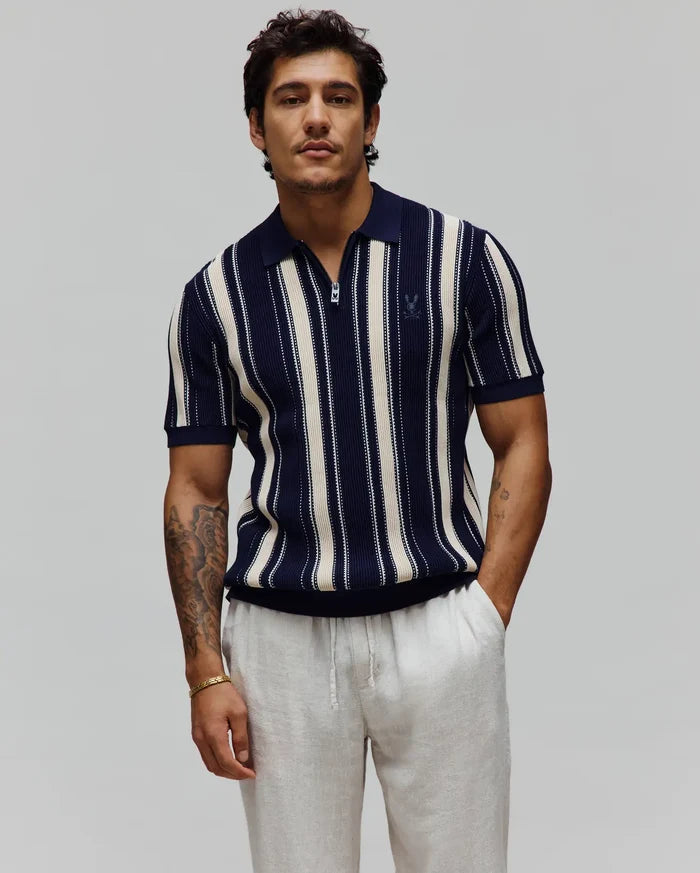 Mens Cliff Knit Zip Polo in navy and cream vertical stripes, featuring a quarter-zip placket, ribbed knit texture, classic fit, and a small embroidered Psycho Bunny skull logo on the left chest.