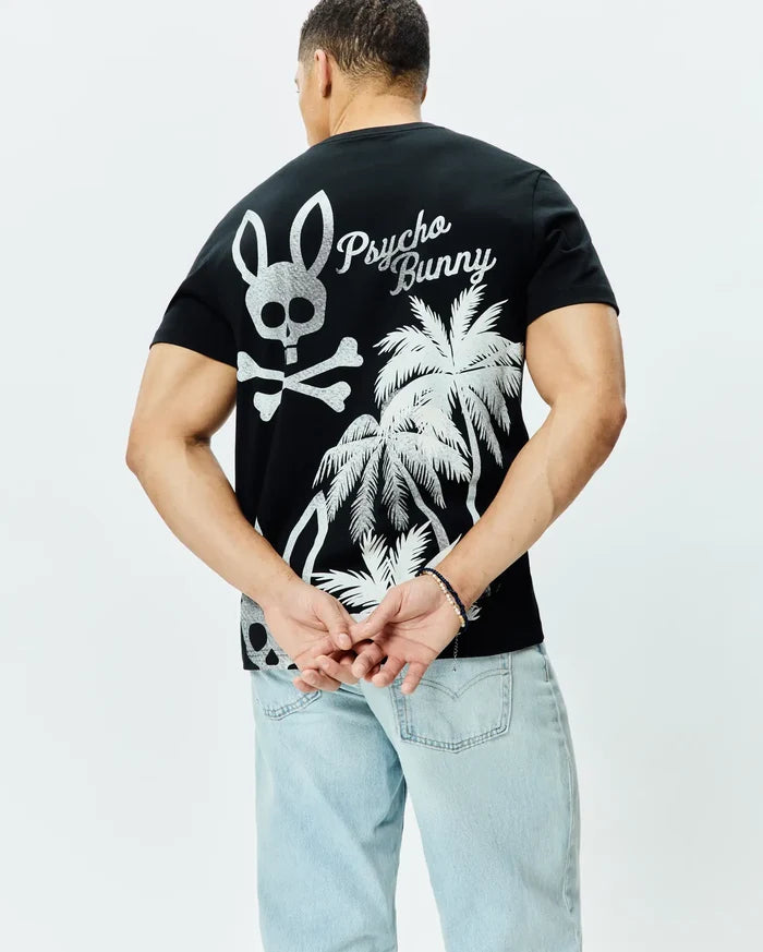 Mens Colin Back Graphic Tee, black jersey knit, classic fit, featuring a large silver Psycho Bunny skull and crossbones, script logo, and palm tree graphic on the back.