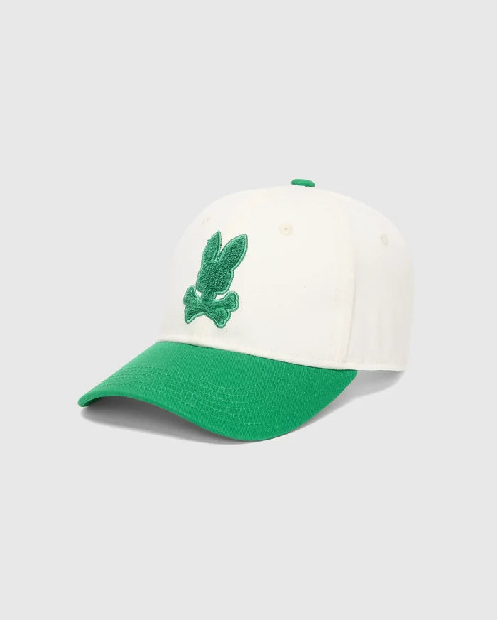 Mens Craig Baseball Cap in cream cotton twill with a vibrant green brim and matching top button, featuring a prominent, textured green embroidered Psycho Bunny skull logo on the front.
