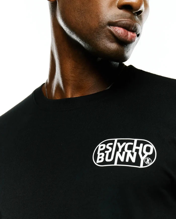 Mens Dariel Long Sleeve Back Graphic Tee in black jersey knit, featuring a white oval graphic print with stylized Psycho Bunny text and a small bunny skull logo on the front chest.
