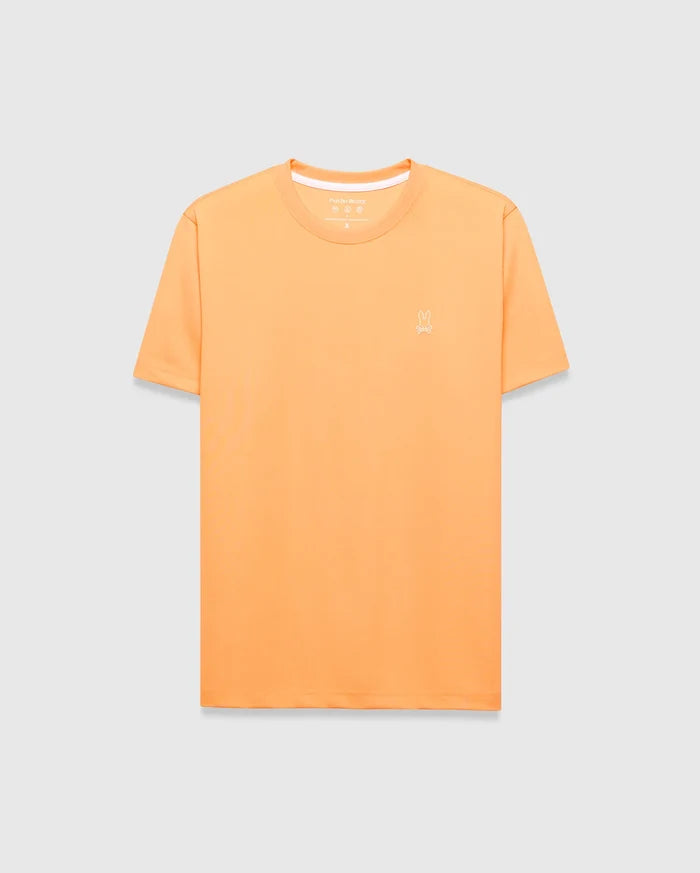 Mens Dash Bunny Sport Tee, a classic fit orange t-shirt made from smooth performance fabric, featuring a small white embroidered Psycho Bunny skull logo on the left chest and white inner collar trim.