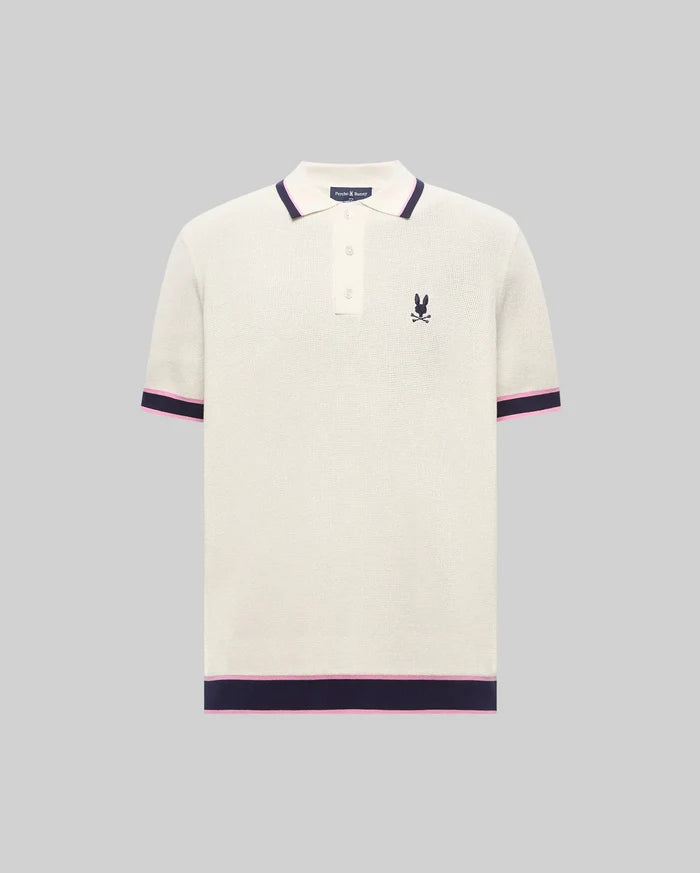 Mens Dax Knit Polo, cream textured knit with navy and pink striped ribbed collar, cuffs, and hem, featuring a small embroidered navy Psycho Bunny skull logo on the left chest.