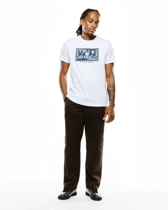 Mens Desmond Graphic Tee, a white classic fit jersey t-shirt featuring a large center chest graphic of multiple blue and grey Psycho Bunny skull logos in a rectangular frame with Psycho Bunny text.