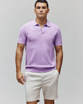 Mens Devon Knit Polo in lavender, featuring a textured knit fabric, classic fit, open collar, and a small embroidered Psycho Bunny skull logo on the left chest.