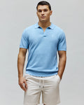 Mens Devon Knit Polo, sky blue textured knit with an open collar, classic fit, and a small embroidered white Psycho Bunny skull logo on the left chest, featuring ribbed cuffs and hem.