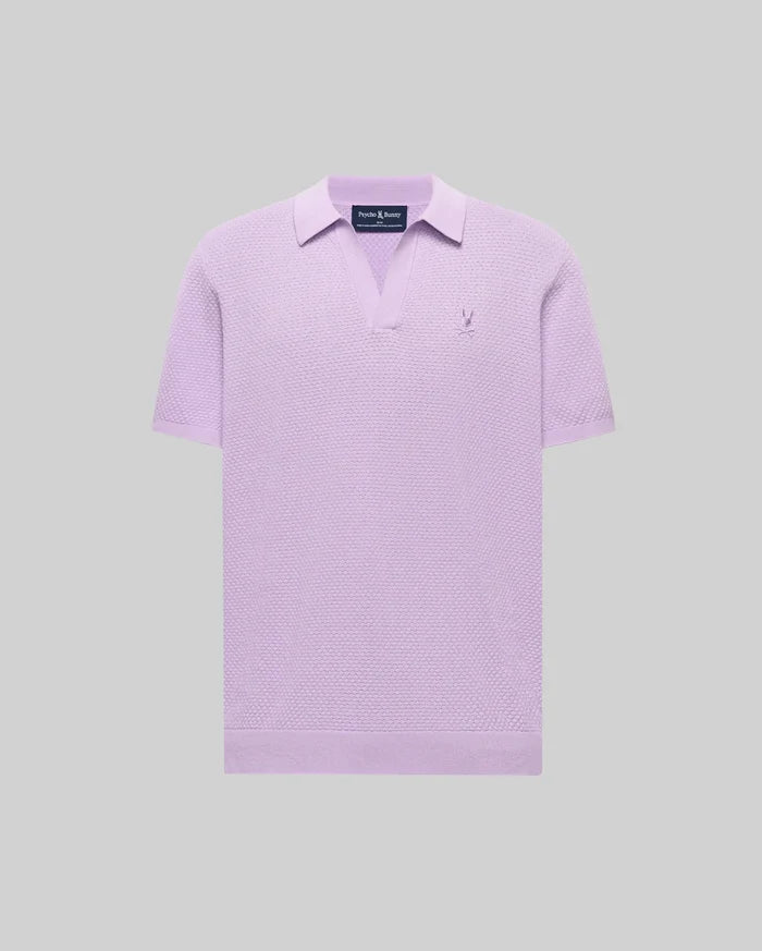 Mens Devon Knit Polo in lavender, featuring a textured knit fabric, open V-neck collar, and a small embroidered Psycho Bunny skull logo on the left chest.