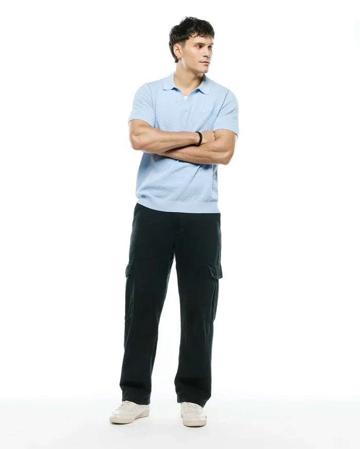 Mens Devon Bubble Stitch Knit Polo, a light blue classic fit polo featuring a textured bubble stitch knit fabric and a small embroidered Psycho Bunny skull logo on the left chest.