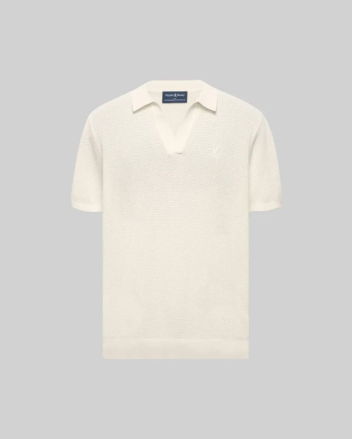 Cream Mens Devon Knit Polo with a textured knit fabric, open collar, short sleeves, ribbed cuffs and hem, featuring a small, tonal embroidered Psycho Bunny skull logo on the left chest.