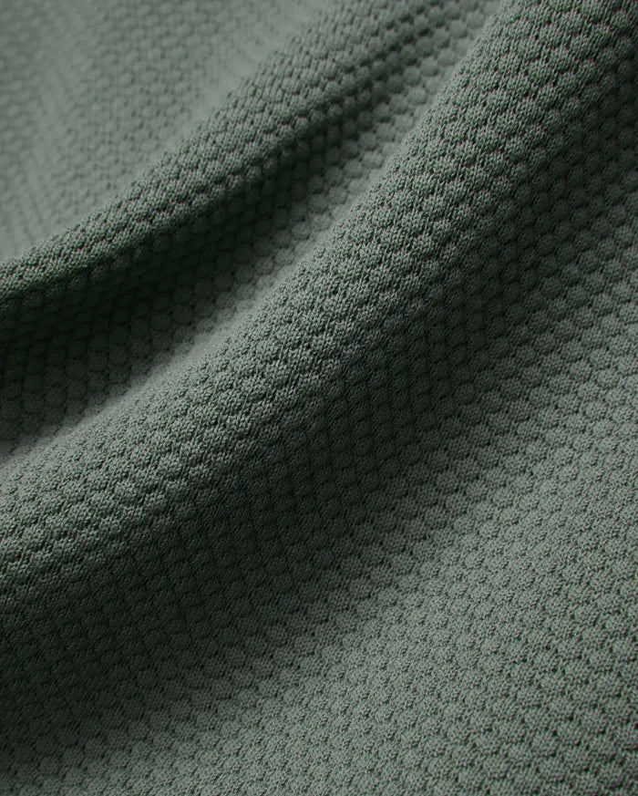 Mens Devon Knit Polo in a rich, muted sage green, featuring a premium, breathable textured knit fabric with a subtle, refined pattern, perfect for elevated streetwear style.