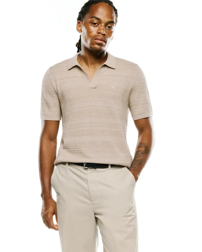 Mens Devon Braided Stitch Knit Polo in beige, featuring a classic fit, open collar, and a small embroidered Psycho Bunny skull logo on the left chest.