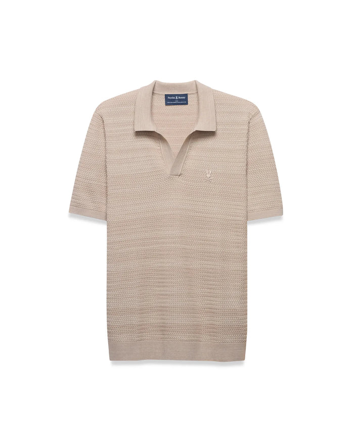MENS DEVON BRAIDED STITCH KNIT POLO in beige, featuring a classic fit, textured braided knit fabric, spread collar, V-neck placket, and a small, embroidered tone-on-tone Psycho Bunny skull logo on the left chest.