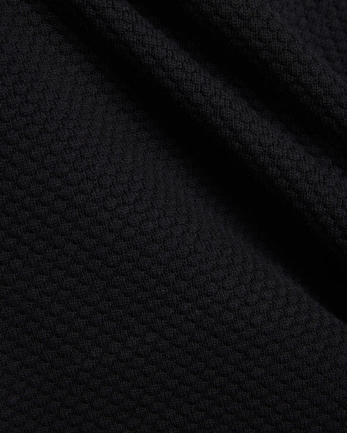 Mens Devon Knit Short in rich black, showcasing a premium, subtly textured knit fabric with a refined mini-waffle pattern, embodying sophisticated streetwear style.