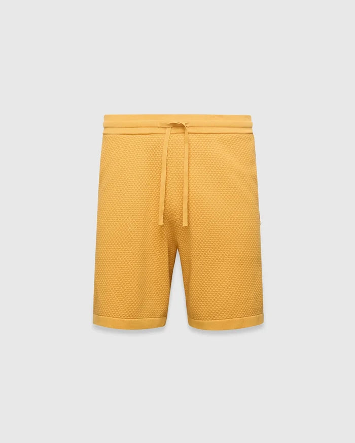 Mustard yellow Mens Devon Knit Short, a relaxed fit, premium textured waffle knit short with an adjustable drawstring waist and ribbed hem.