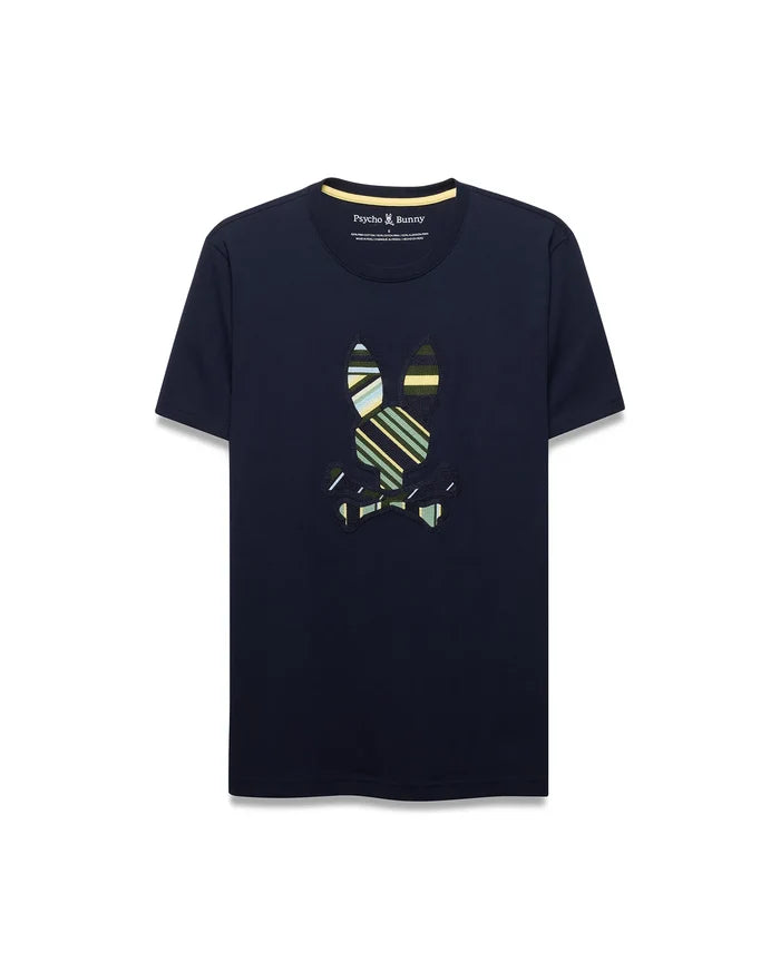 Mens Drew Embroidered Graphic Tee, a navy classic fit jersey t-shirt with a large, center chest embroidered Psycho Bunny skull logo featuring bold green, yellow, and white stripes, and a yellow inner collar trim.