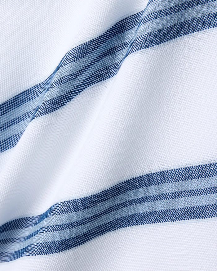 Mens Drew Striped Pique Polo featuring a crisp white pique fabric base, accented with bold horizontal stripes in varying shades of navy blue and light blue, each stripe intricately textured with a fine dotted pattern.