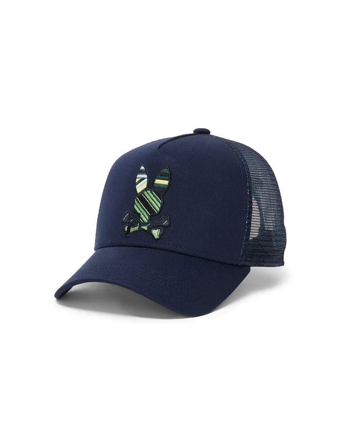 Mens Drew Trucker Cap, navy cotton twill front with breathable mesh back, featuring a large, prominently embroidered Psycho Bunny skull logo in green, yellow, and white stripes.