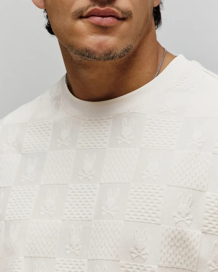 Cream Mens Dustin Oversized Tee with an all-over textured knit checkered pattern, featuring alternating squares of subtle texture and embossed Psycho Bunny skull logos.