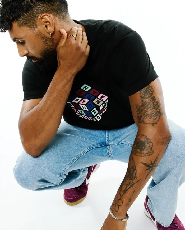 Mens Eddy Graphic Tee: Black classic fit jersey knit t-shirt featuring a large central multicolor Rubik's Cube-style graphic with individual colored squares spelling PSYCHO BUNNY.