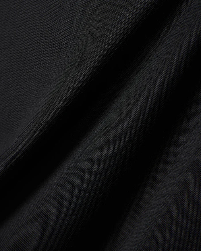 MENS EDWIN SPORT POLO in premium black pique fabric, featuring a classic fit and the signature embroidered Psycho Bunny skull logo on the chest, embodying refined streetwear style.