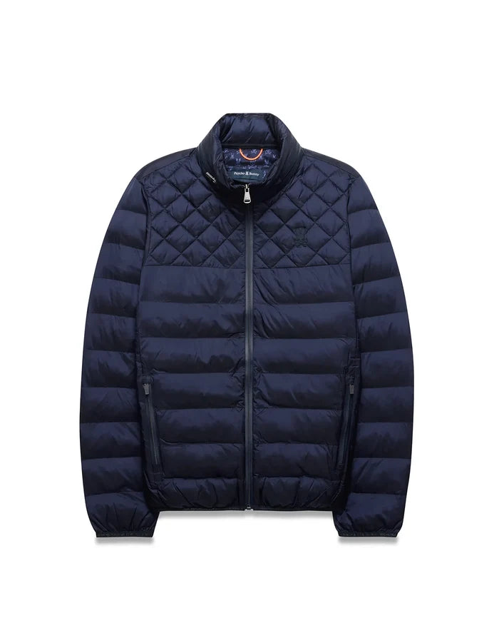 Navy Mens Emerik Puffer Jacket, quilted upper, horizontal baffles, stand collar, full zip, zippered pockets. Small embroidered Psycho Bunny skull on left chest, colorful patterned inner collar.