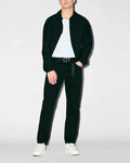 Black collared shirt jacket with small embroidered Psycho Bunny logo on left chest, over white jersey tee, dark Mens Emerson Denim Pant with branded keychain, and white sneakers.
