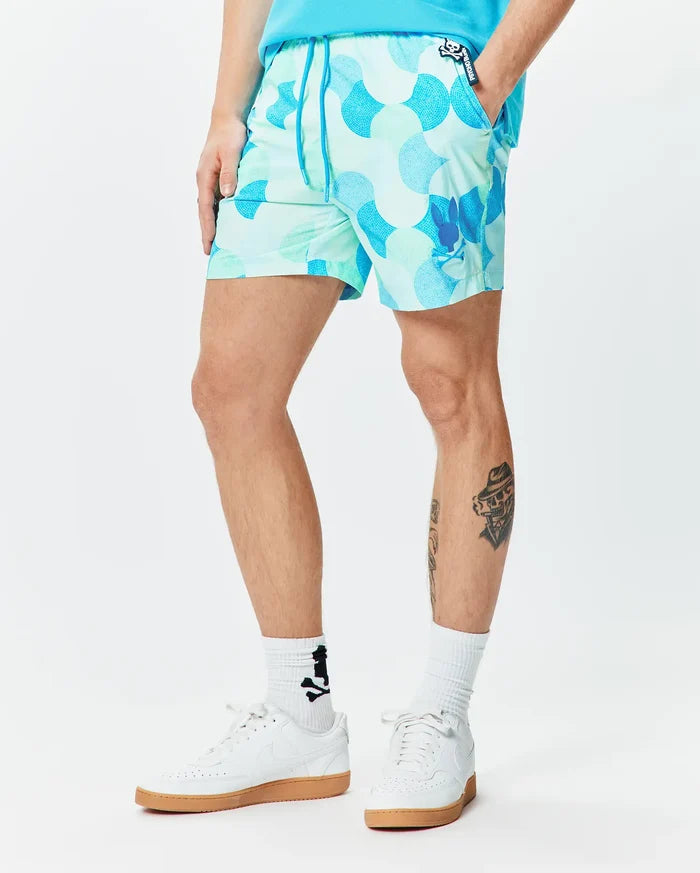 Mens Ethan Swim Trunk 6, featuring a vibrant mint green and blue mosaic pattern, classic fit, smooth fabric, with a small Psycho Bunny skull logo on the left leg and a branded pocket label.
