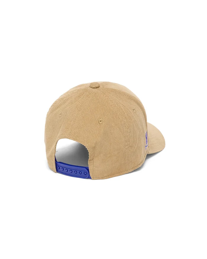 Mens Finnley Wordmark Corduroy Trucker Cap in beige, featuring a textured corduroy fabric, partially visible embroidered wordmark logo on the side, and a vibrant blue snapback closure.
